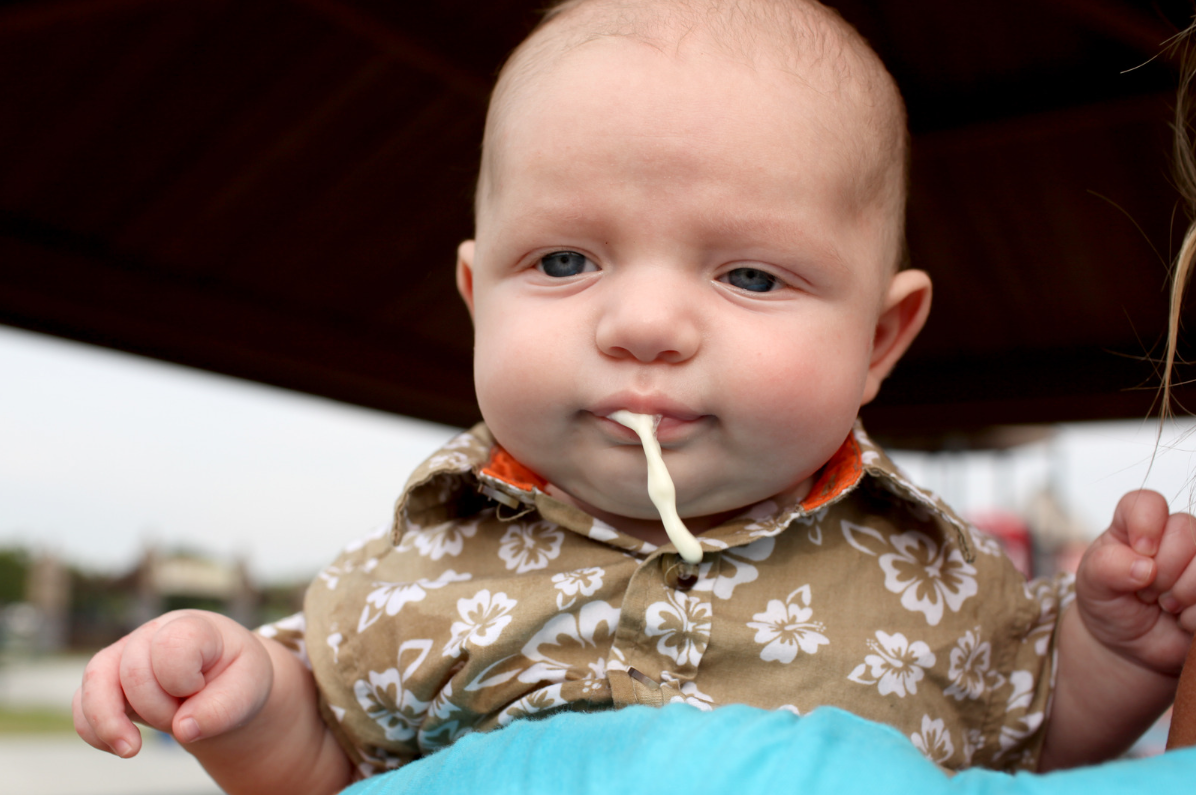 A baby spitting up due to acid reflux.