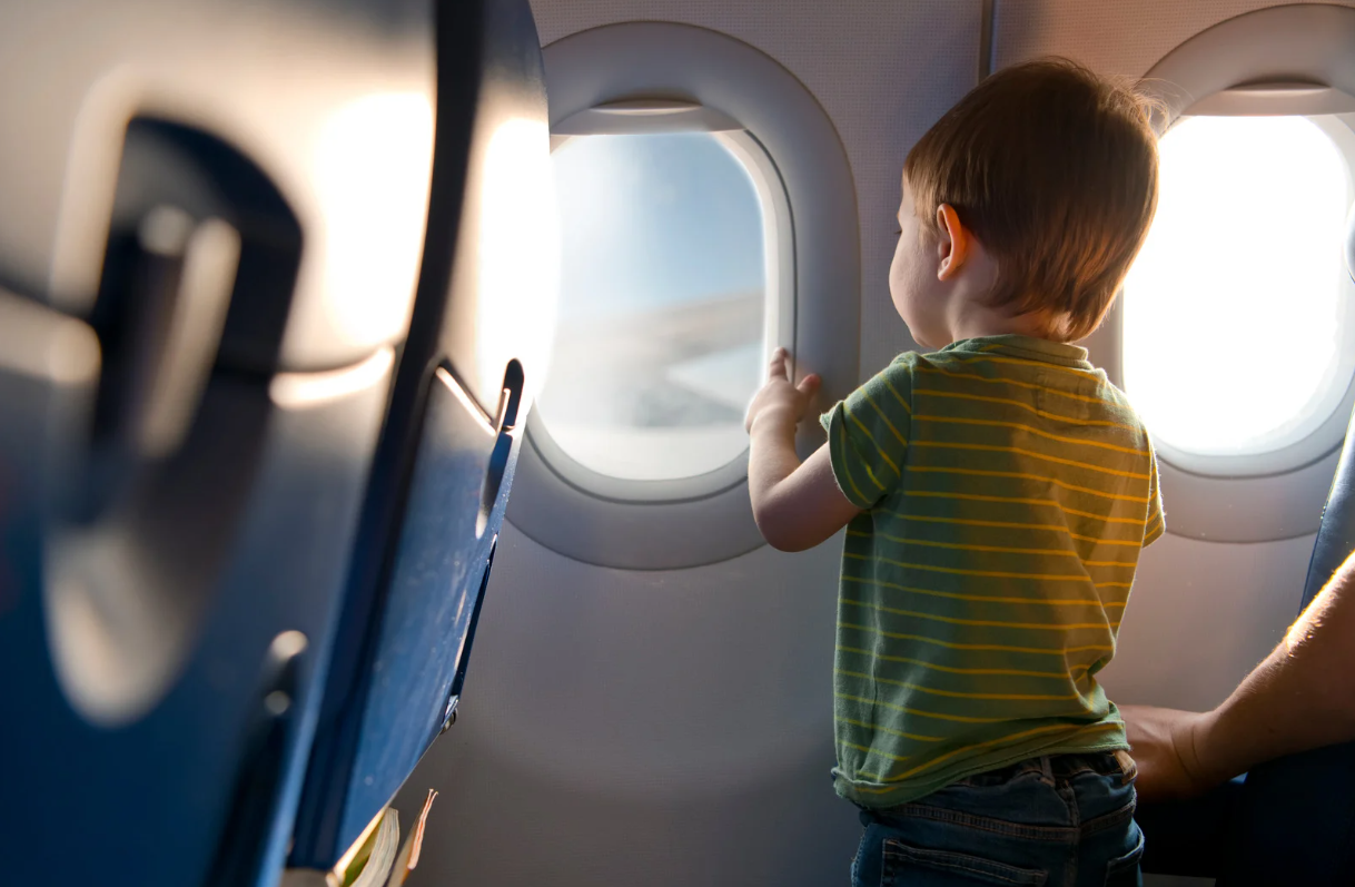 A child flying on an airplane before getting ear pain.