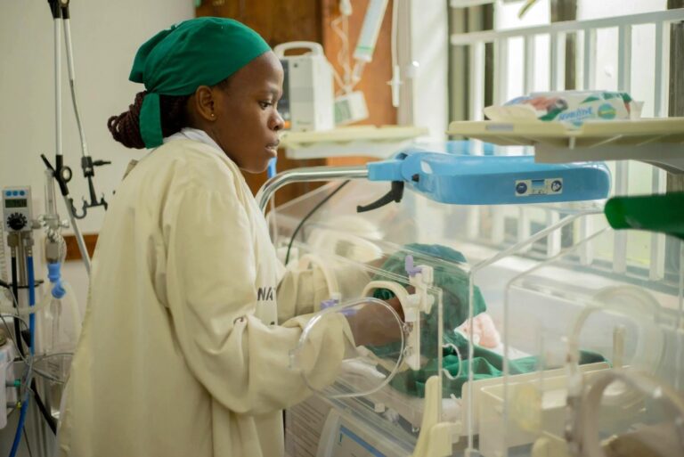 Doctor in NICU unit with a newborn with Transient Tachypnea.