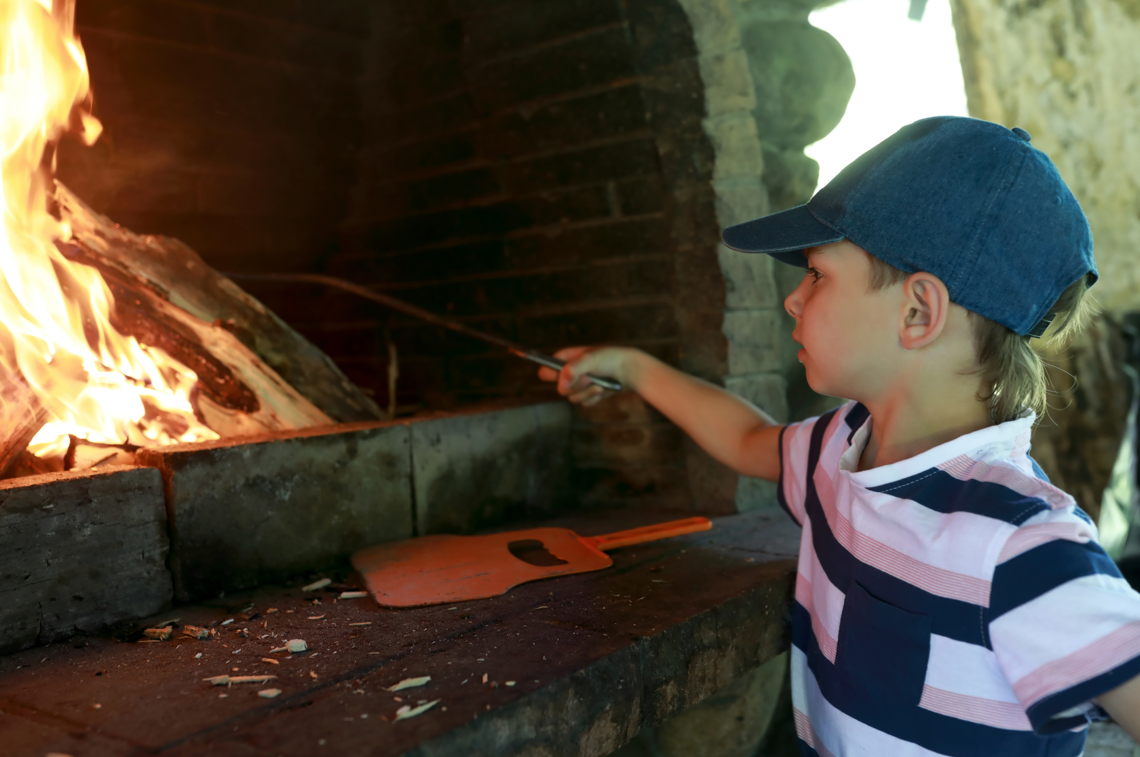 Child about to be burnt on a fire.