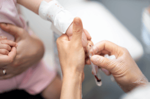 A baby being administered a blood test to check for thalassaemia.