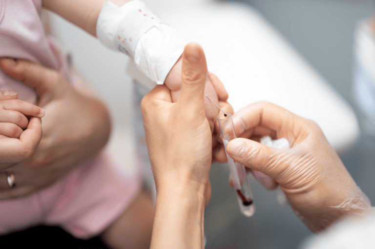 A baby being administered a blood test to check for thalassaemia.