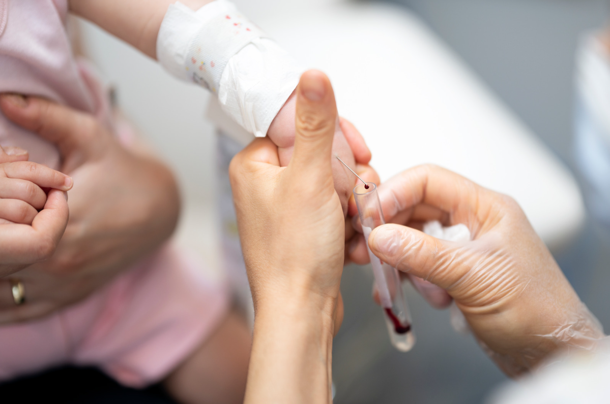 A baby being administered a blood test to check for thalassaemia.