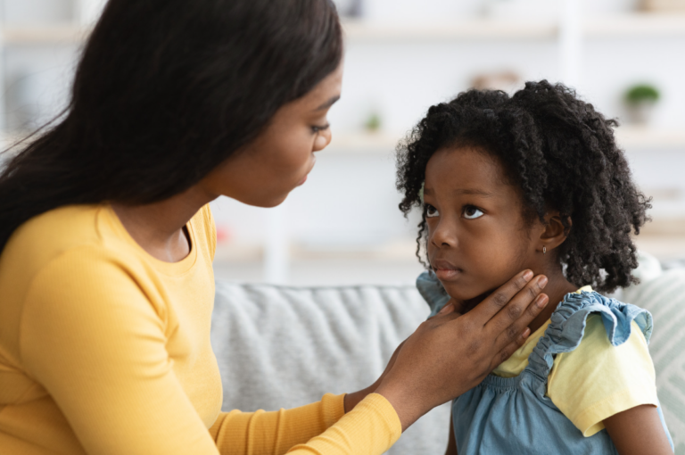 Mother checking child with strep throat.